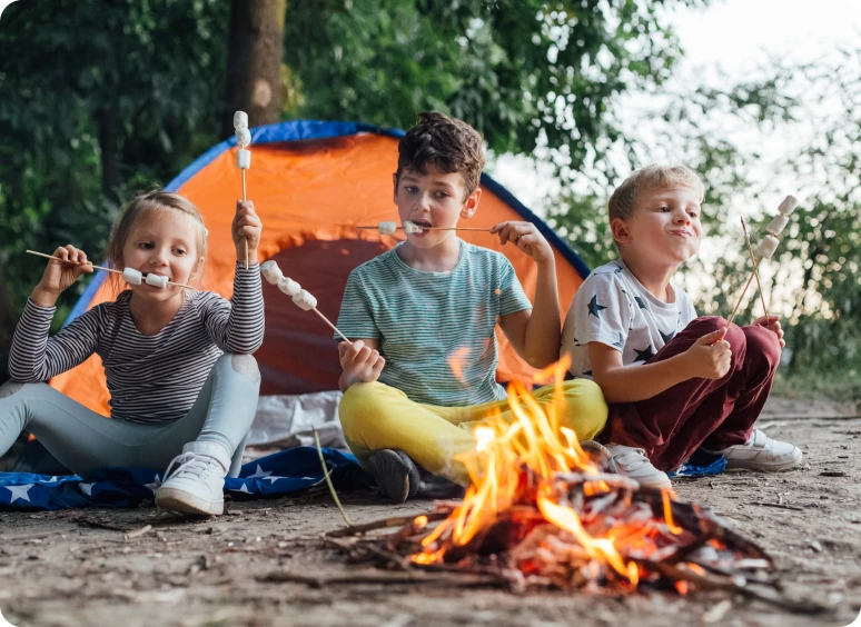 Children enjoying campfire treat