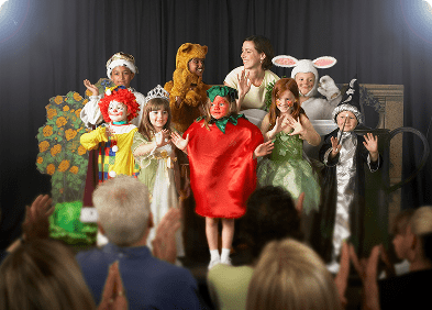 Kids performing in colorful outfits